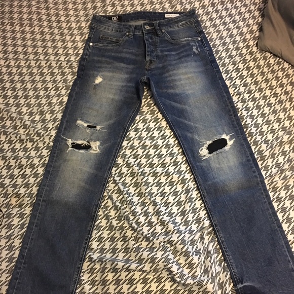 blue jeans with black patches
